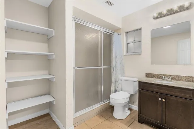 a bathroom with a toilet a sink and a mirror