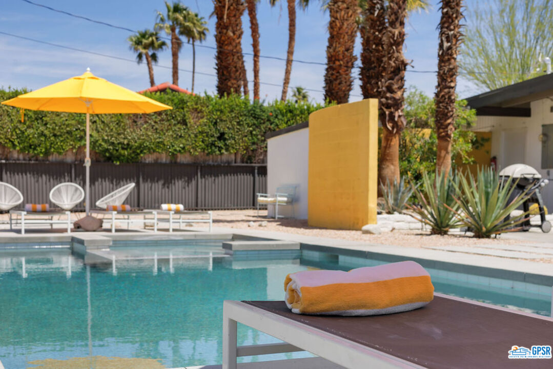 2267 North San Antonio Road Palm Springs, CA 92262 - Photo 1 of 60 a swimming pool with outdoor seating and yard