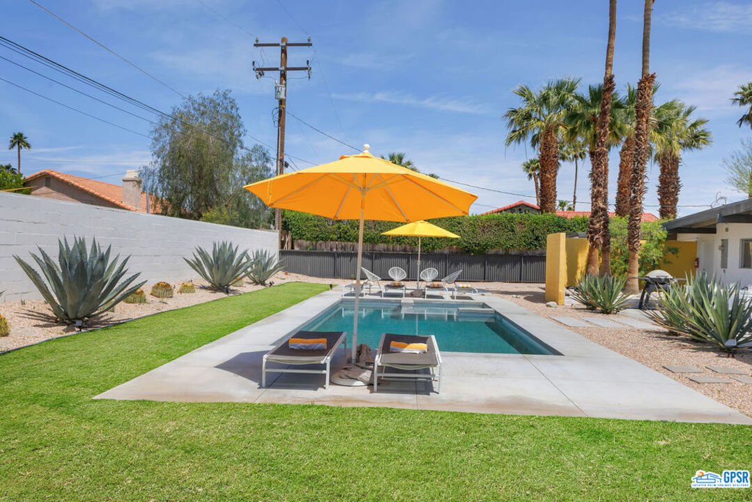 2267 North San Antonio Road Palm Springs, CA 92262 - Photo 17 of 60 a view of a backyard with swimming pool and furniture