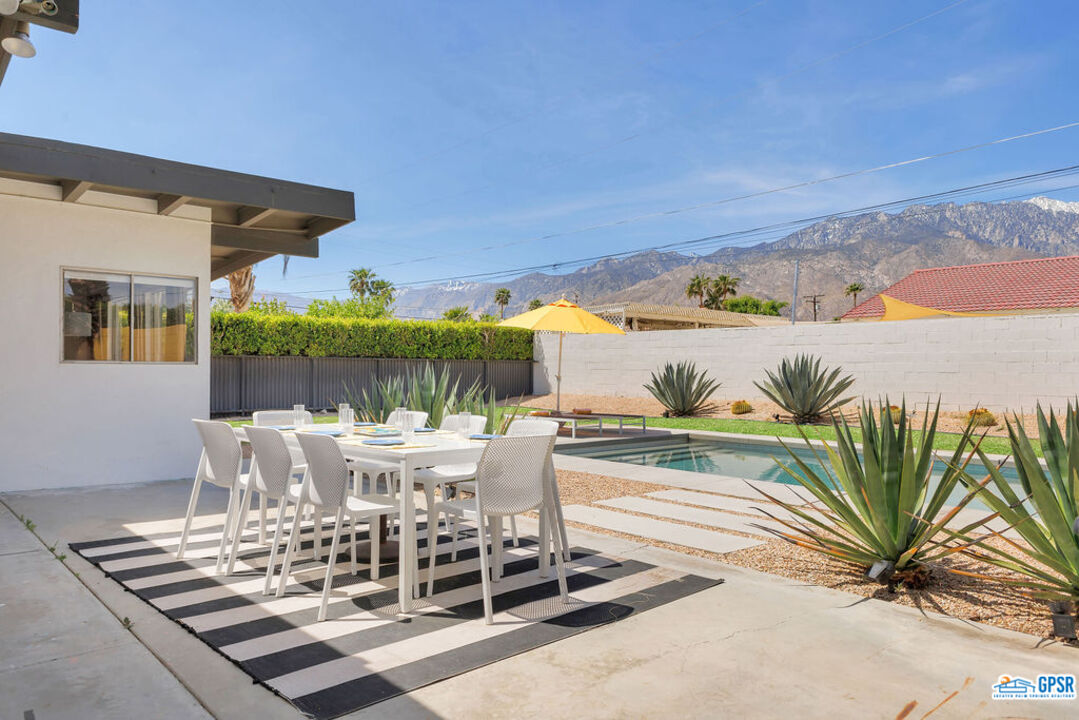 2267 North San Antonio Road Palm Springs, CA 92262 - Photo 19 of 60 a view of a patio with table and chairs and potted plants