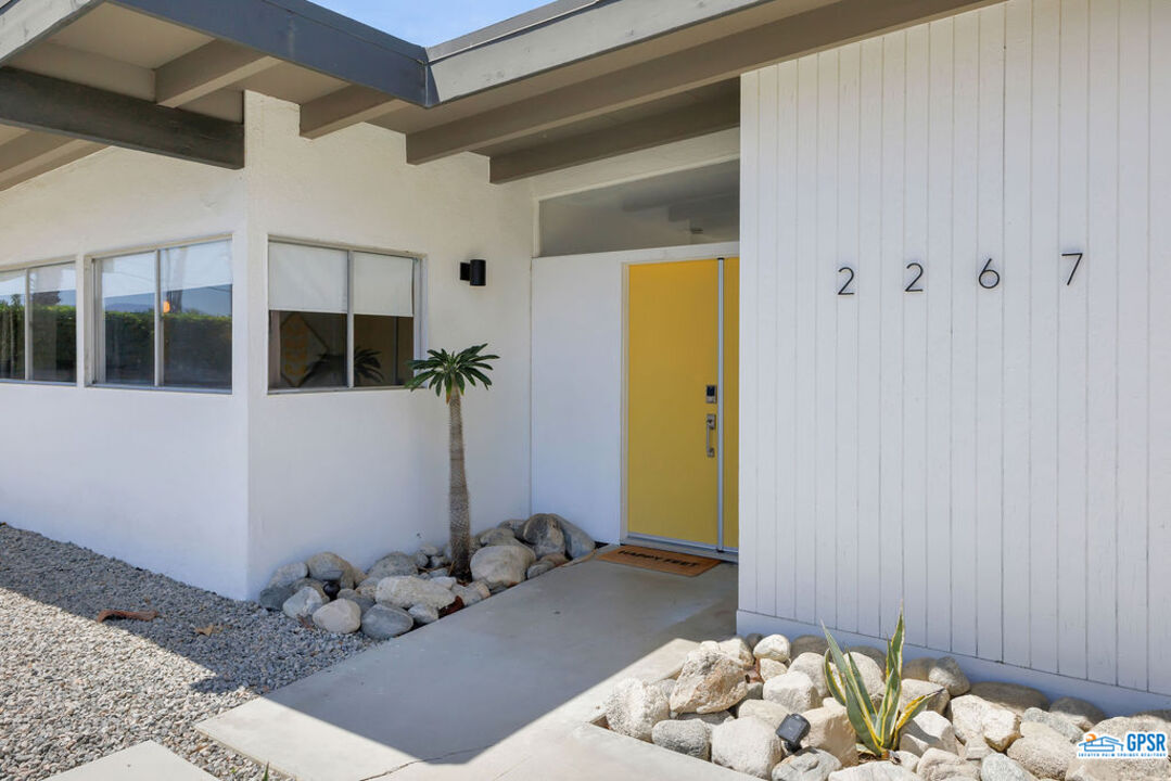 2267 North San Antonio Road Palm Springs, CA 92262 - Photo 23 of 60 a bedroom with a bed and a wooden floor