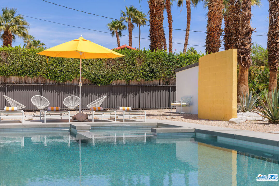 2267 North San Antonio Road Palm Springs, CA 92262 - Photo 27 of 60 a swimming pool with outdoor seating and yard