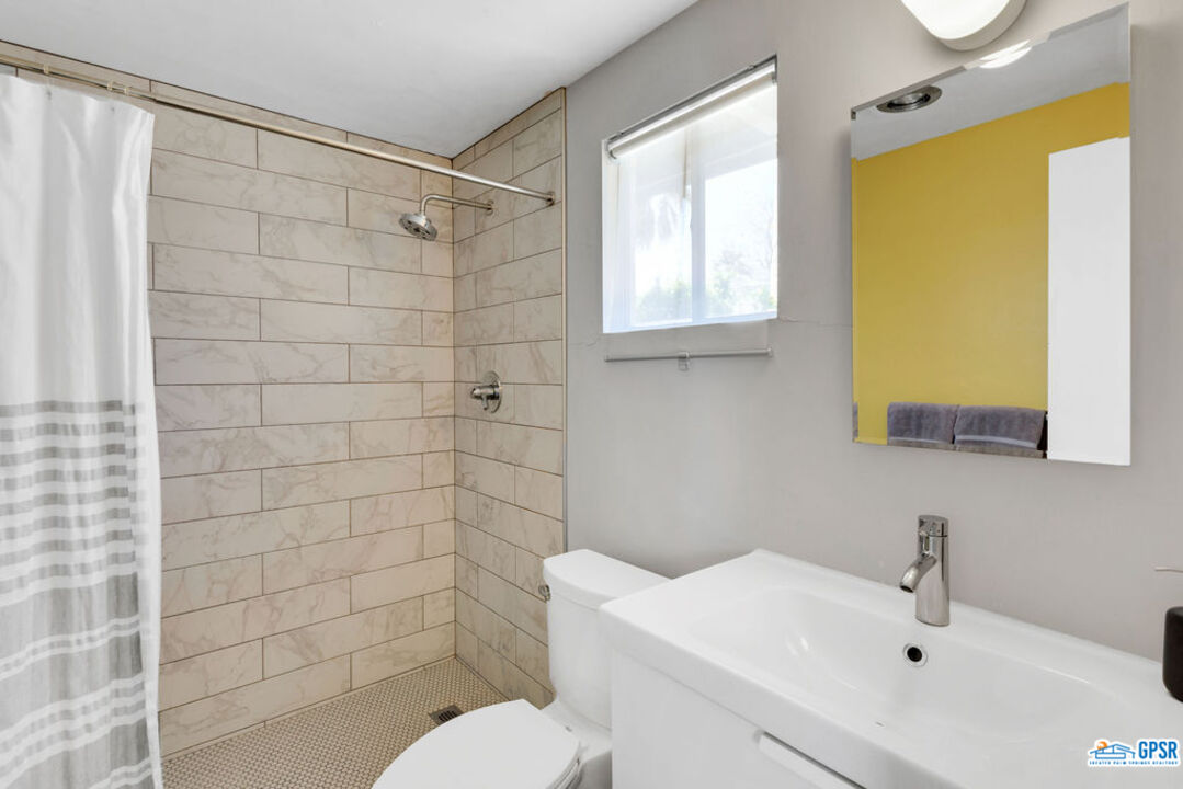 2267 North San Antonio Road Palm Springs, CA 92262 - Photo 33 of 60 a bathroom with a sink a toilet and shower