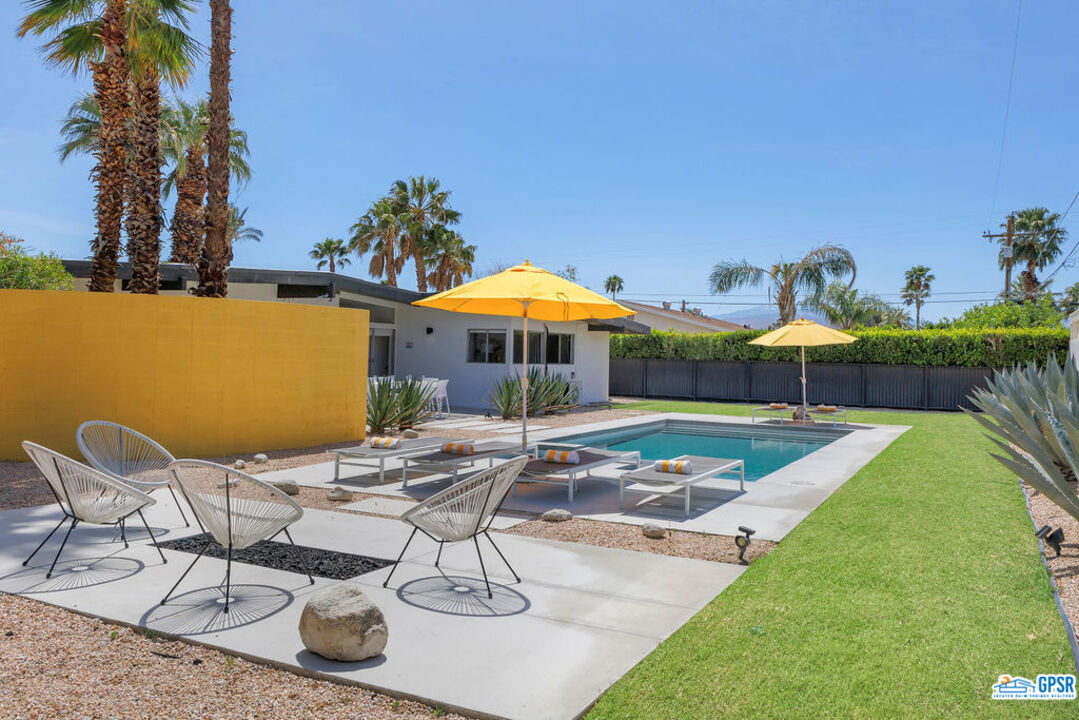 2267 North San Antonio Road Palm Springs, CA 92262 - Photo 10 of 60 a patio with a table and chairs under an umbrella