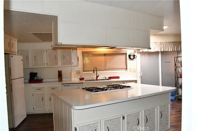 a kitchen with a stove and a refrigerator