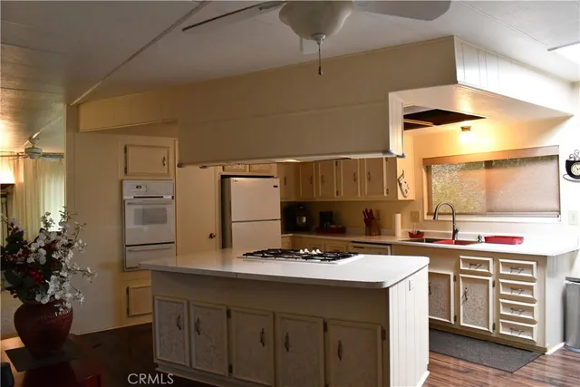 a kitchen with a stove a refrigerator and a dining table