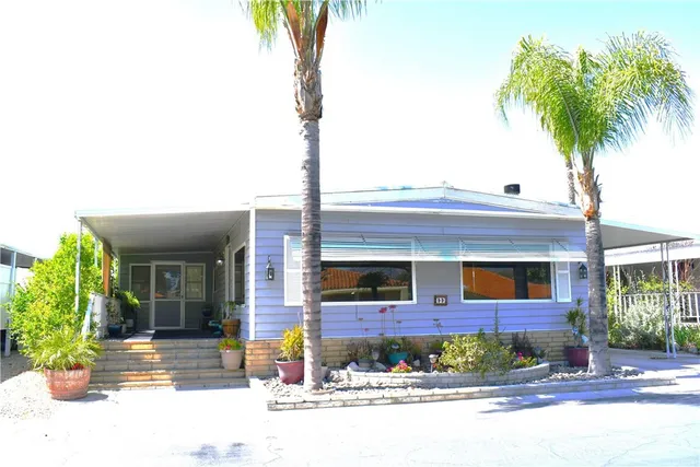 a front view of a house with garden and plants