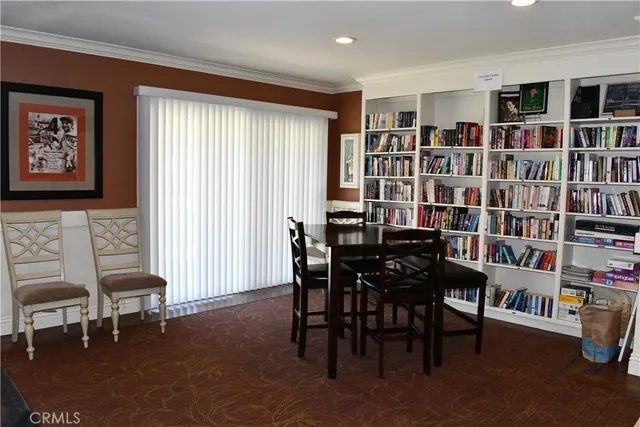 a view of a swimming pool with a table and chairs under an umbrella