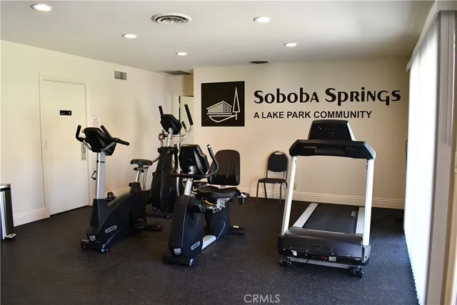 a view of a lake with a yard and large trees