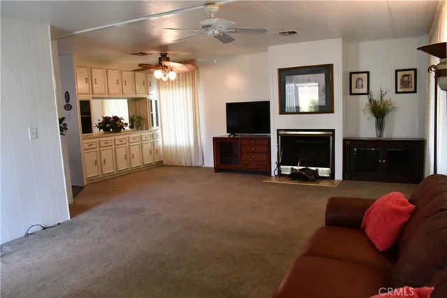 a view of living room kitchen with microwave and furniture