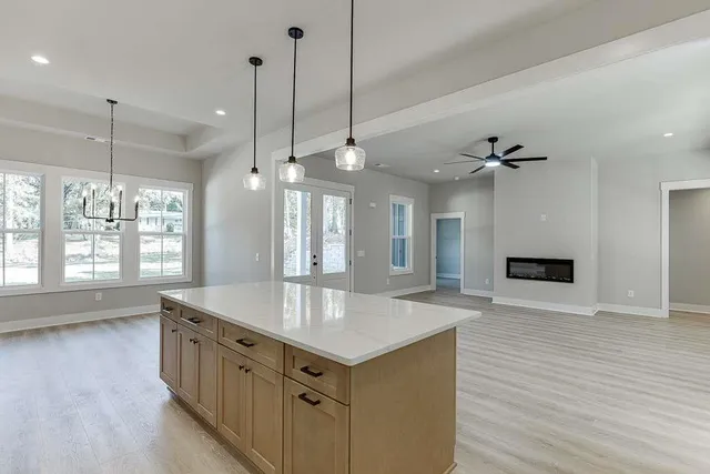 a kitchen with stainless steel appliances granite countertop a sink a oven and a wooden floors