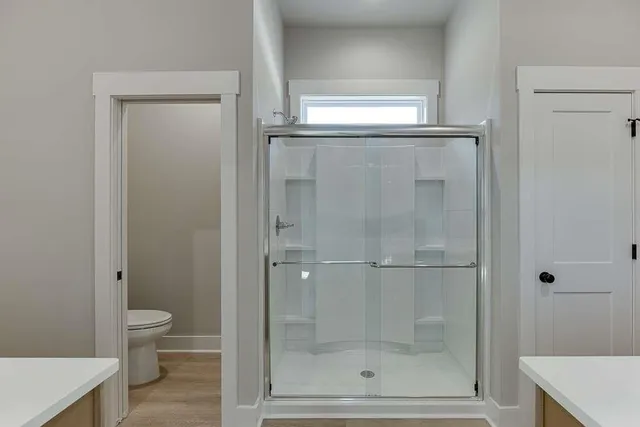 a bathroom with a glass door shower