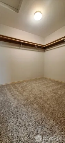 a view of a room with an empty space and a window