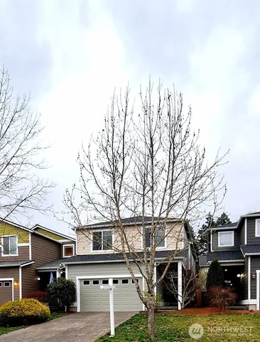 a front view of a building with trees