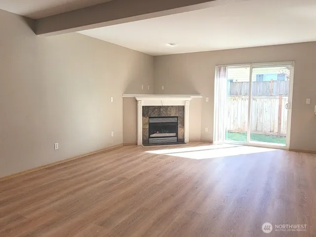 wooden floor fireplace and natural light in room
