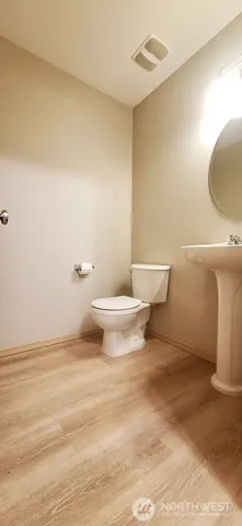 a bathroom with a toilet and a mirror