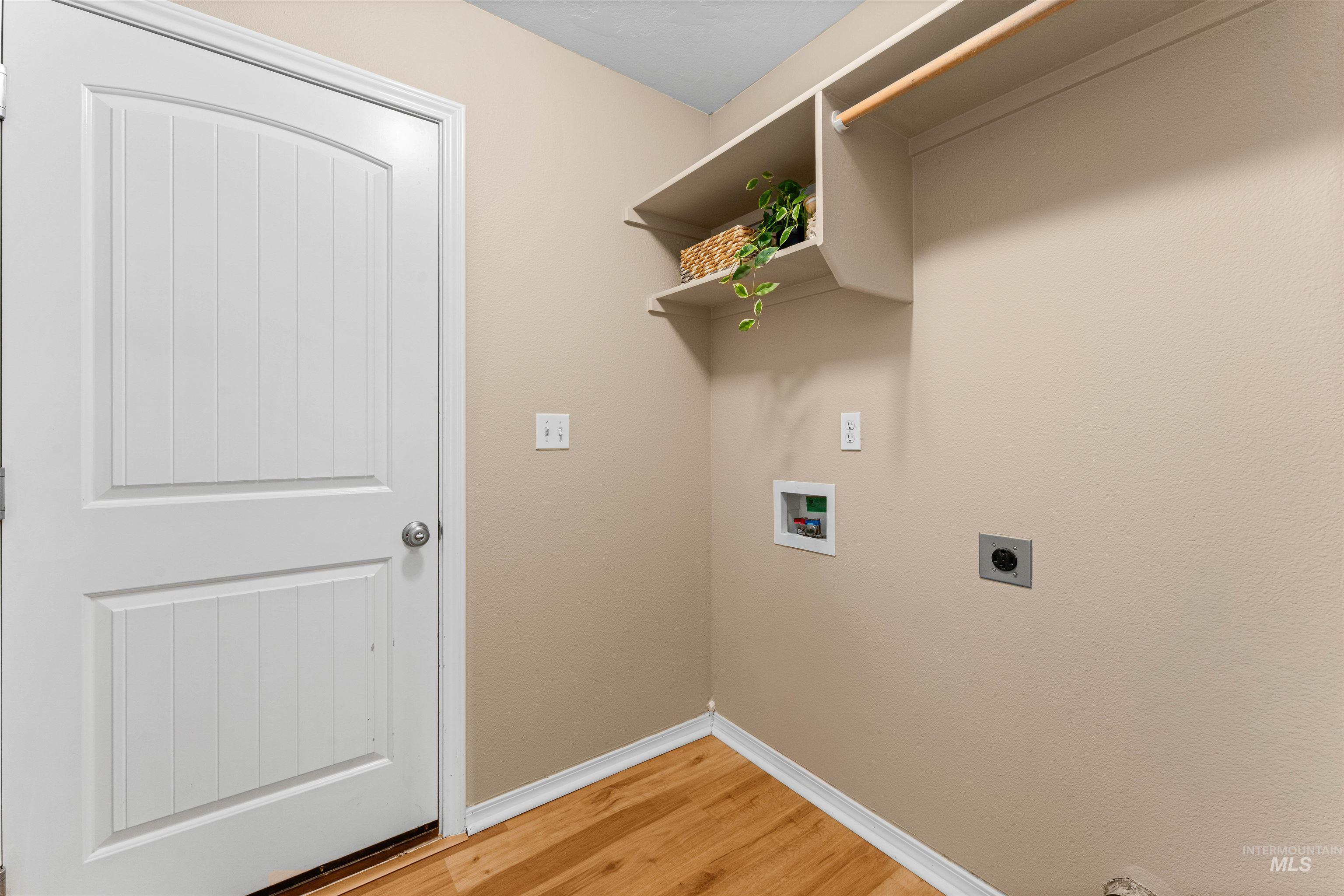 3923 Chatham Court Caldwell, ID 83607 - Photo 27 of 32 Laundry area featuring hookup for an electric dryer, light wood-style flooring, and hookup for a washing machine