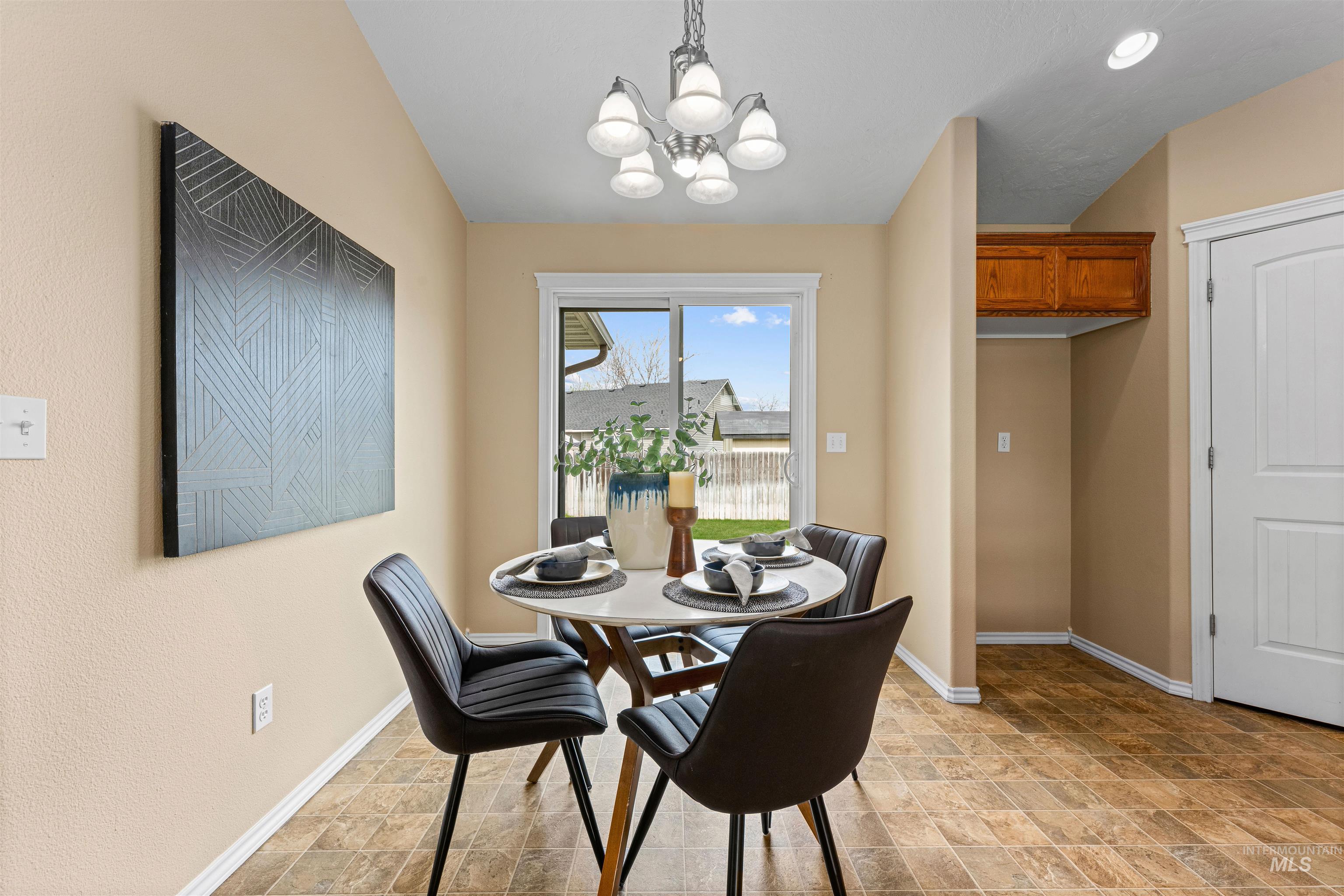 3923 Chatham Court Caldwell, ID 83607 - Photo 8 of 32 Dining room featuring stone finish flooring and hanging lights