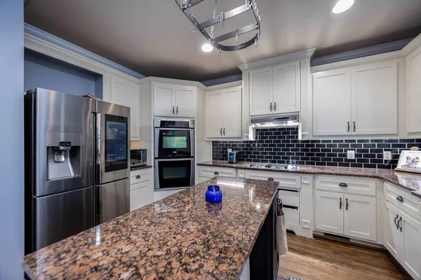 a dining room with furniture entryway and wooden floor