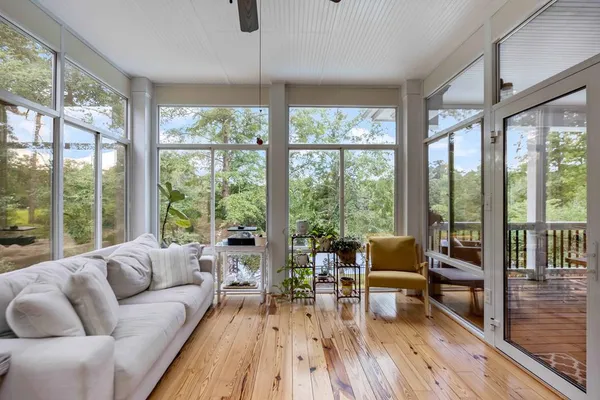 a living room with furniture and large windows