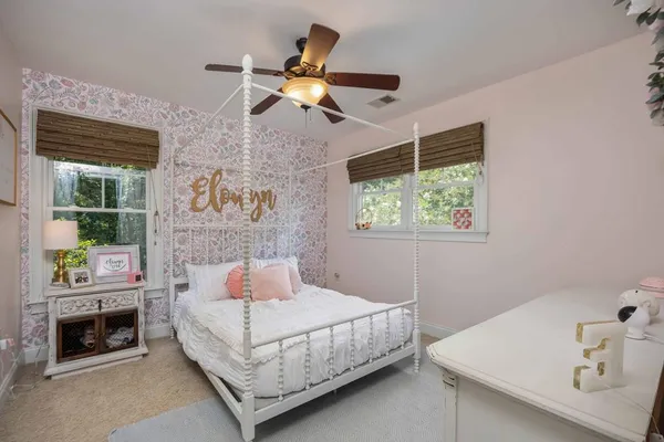 a bedroom with a large bed and a flat tv screen