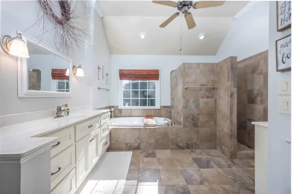 a living room with furniture a flat screen tv and a dining table