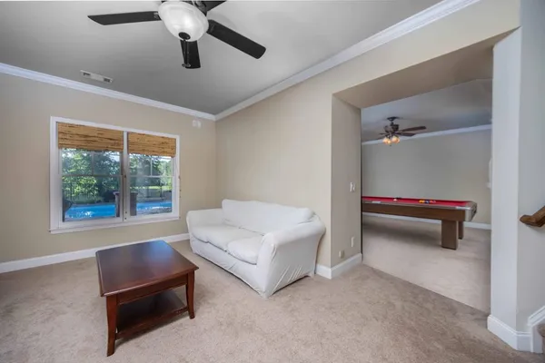 a view of a house with backyard and sitting area