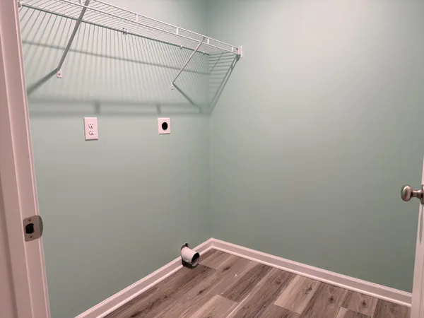 a bathroom with a white wall and a window