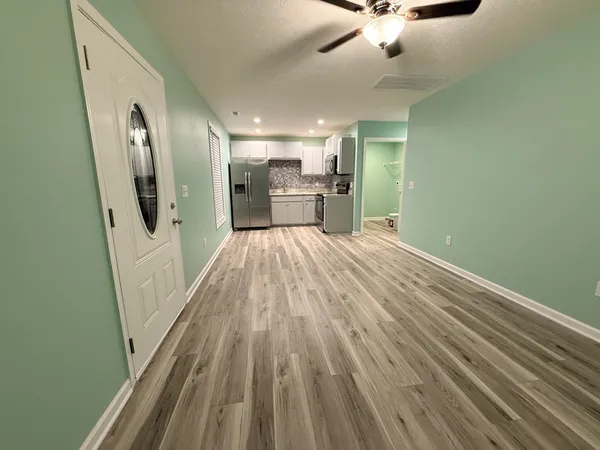 a view of a kitchen from the hallway