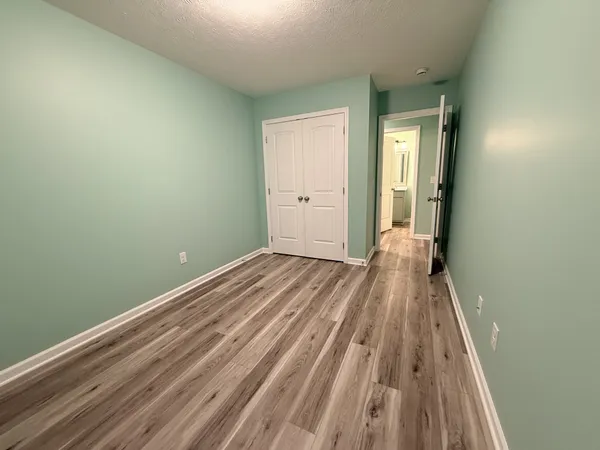 a view of a room with wooden floor and a balcony