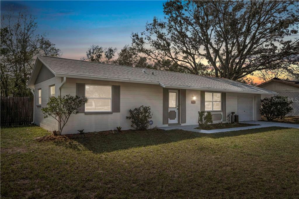 4673 Chamber Court Spring Hill, FL 34609 - Photo 1 of 1 a front view of a house with a yard