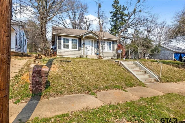 a view of a house with a yard covered in snow