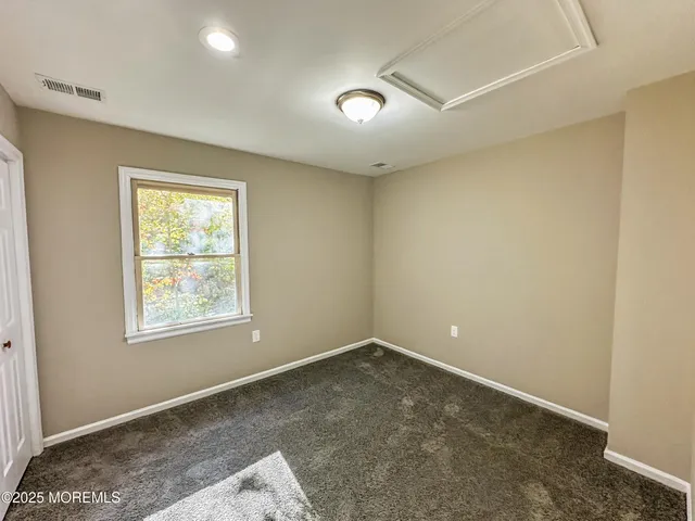 a bedroom with a bed and a potted plant