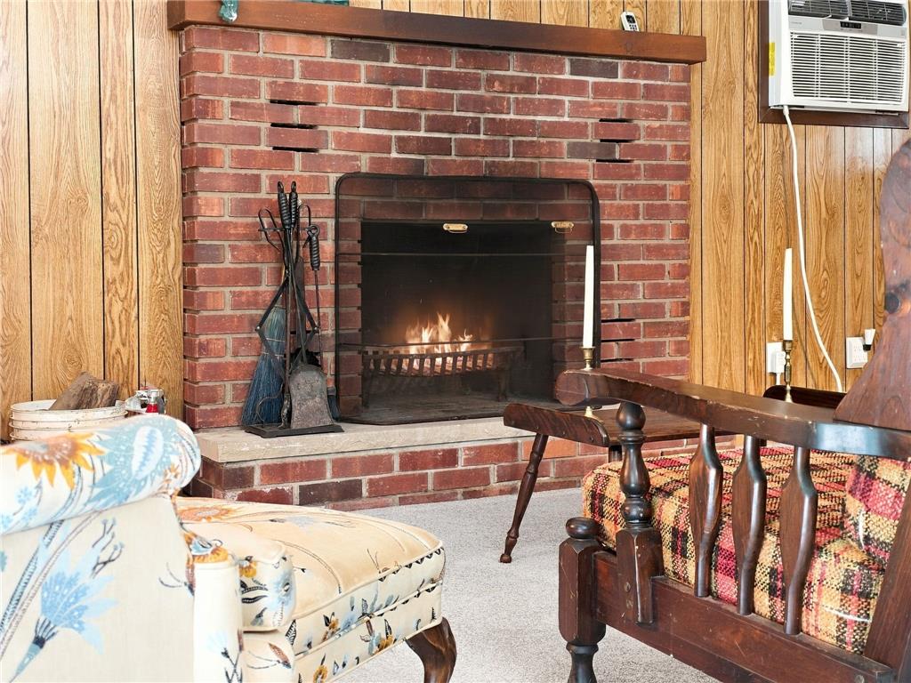 116 Aspen Road Albrightsville, PA 18210 - Photo 17 of 33 A classic brick fireplace anchors the wood-paneled room, bringing warmth and timeless character.