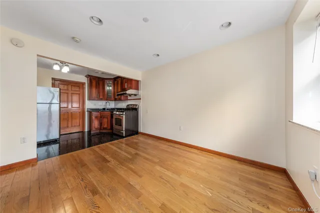 a kitchen with stainless steel appliances kitchen island a refrigerator sink and cabinets