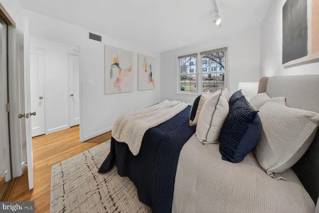 a bed room with a bed and a painting on the wall