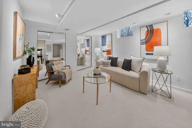 a living room with furniture and a lamp