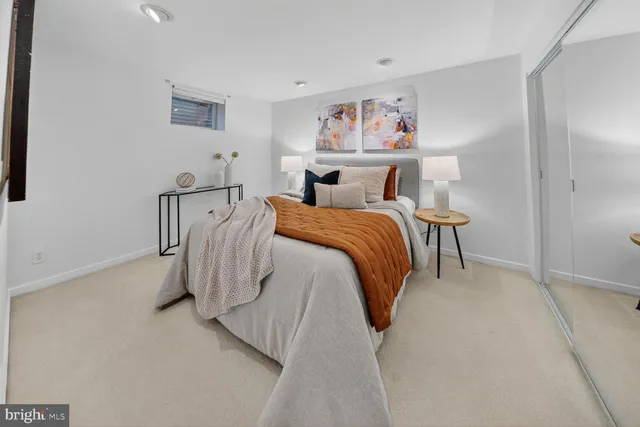 a bedroom with a bed and wall painting