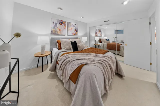 a bed room with a bed and a painting on the wall