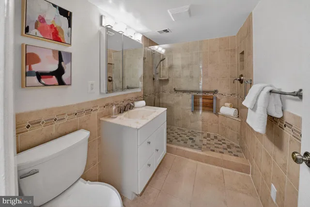 a bathroom with a sink mirror vanity and toilet