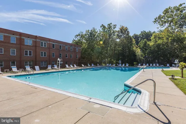 a view of swimming pool outdoor seating and lake view
