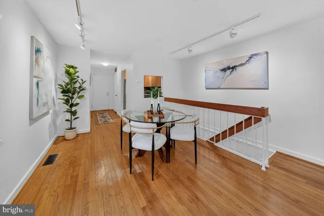 a dining room with furniture and wooden floor