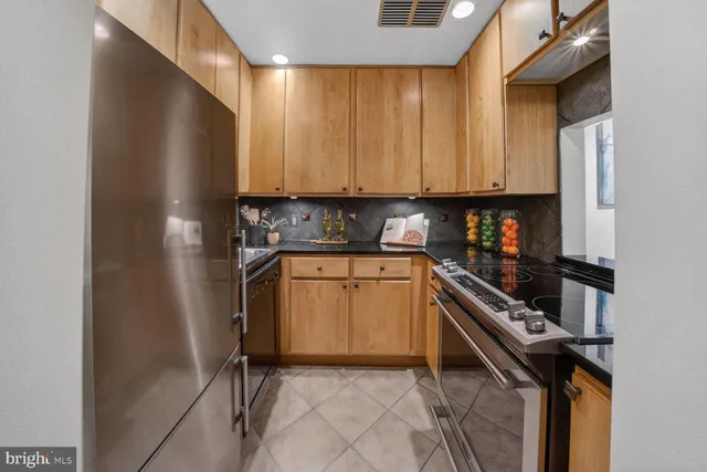 a kitchen with a refrigerator a stove a washer and dryer