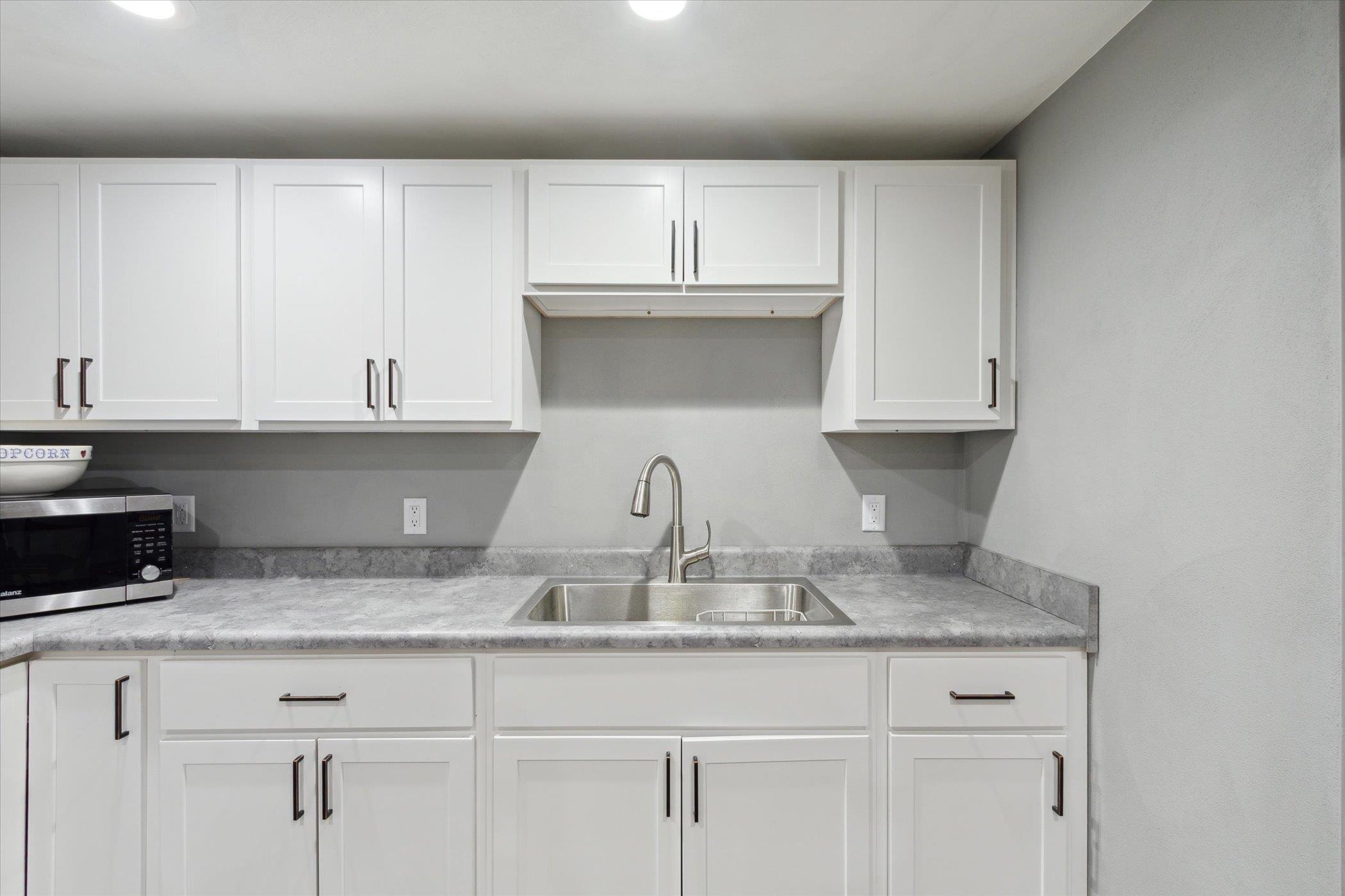 505 East State Line Road Orangeville, IL 61060 - Photo 33 of 58 a kitchen with granite countertop white cabinets and a sink