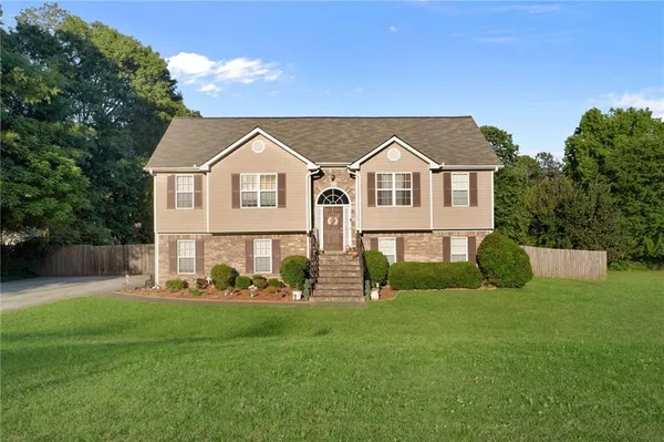 a front view of house with yard and green space