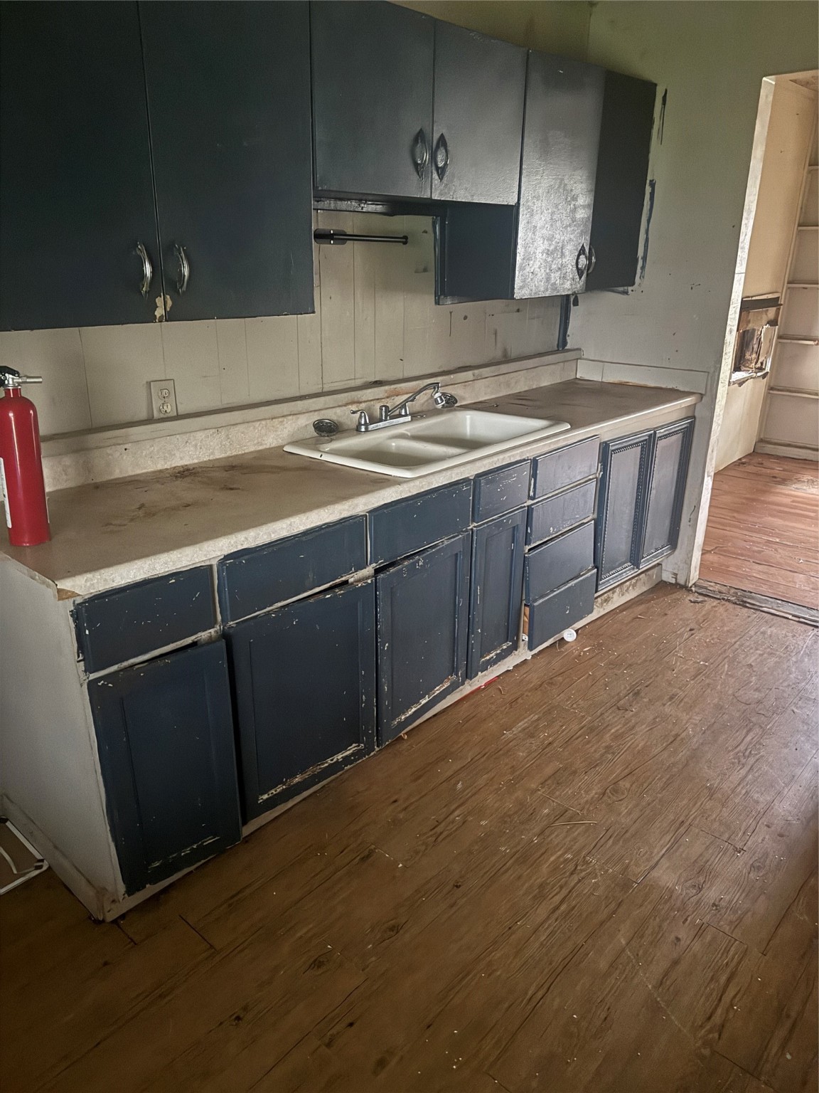 5950 Doolittle Boulevard Houston, TX 77033 - Photo 13 of 25 a kitchen with a sink a stove and cabinets