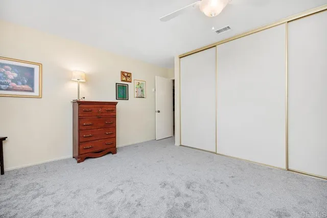 a view of a workspace with furniture and a bookshelf