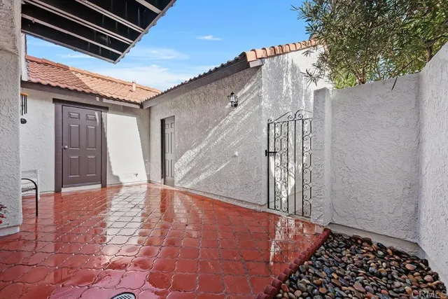 a room with wooden floor and potted plant