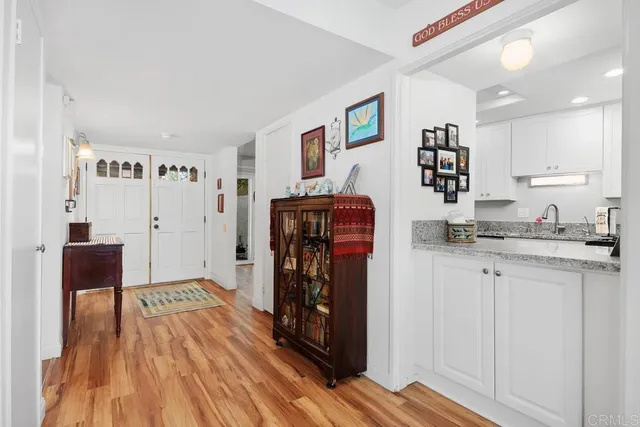 a bedroom with a bed a large window and book shelf