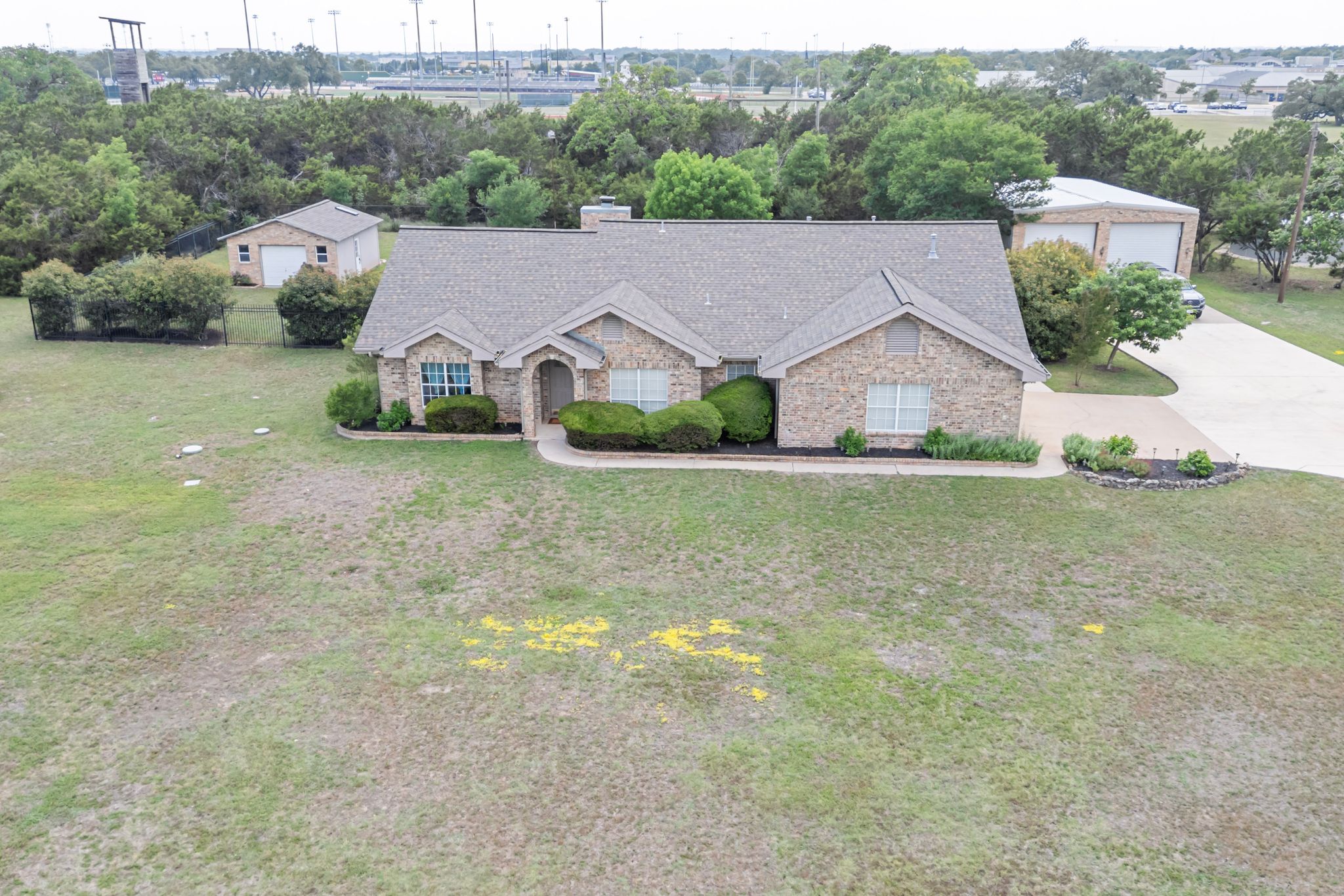 221 Breakaway Road Cedar Park, TX 78613 - Photo 4 of 39 Ranch-style home featuring stone siding, a front yard, roof with shingles, and a chimney